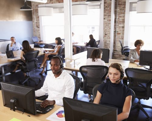 View Of Staff In Busy Customer Service Department